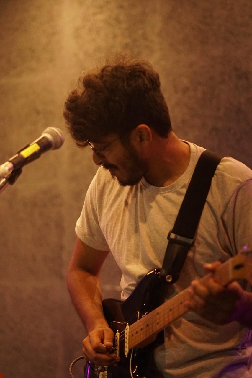 Sanjith performing live with electric guitar
